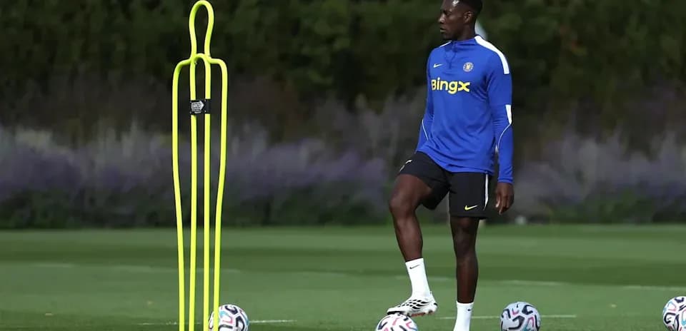 Player practicing near training mannequins and soccer balls