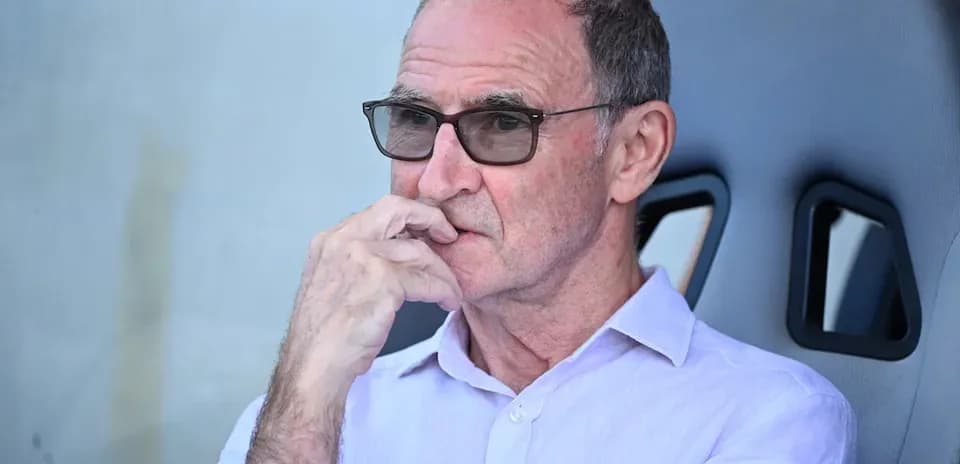 Person sitting on bench with glasses, deep in thought