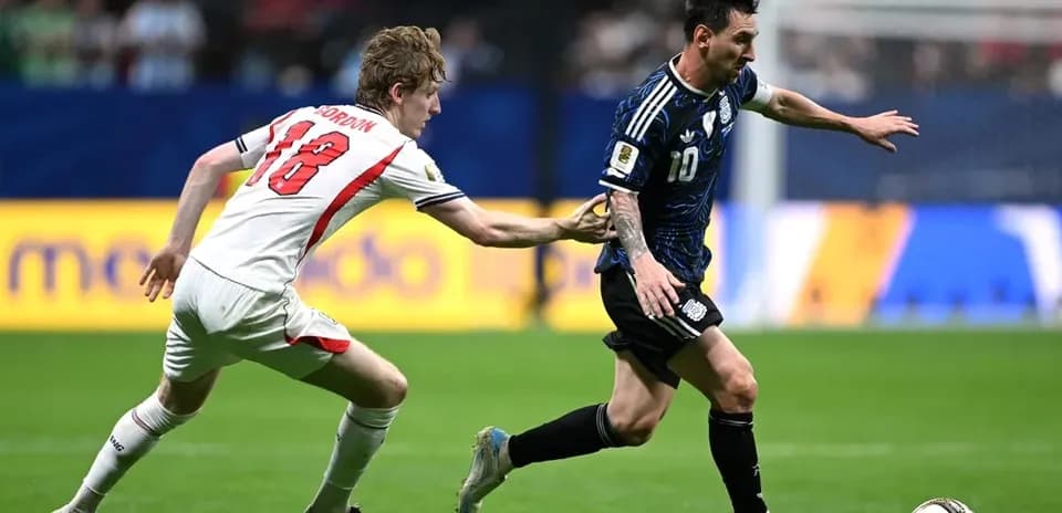 Player in blue jersey evading defender during match