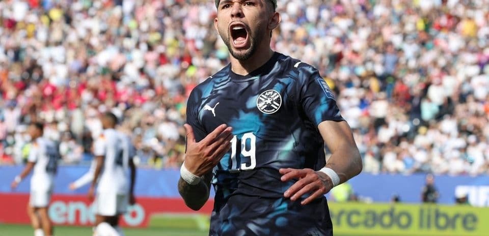 Player celebrating a goal in front of crowd