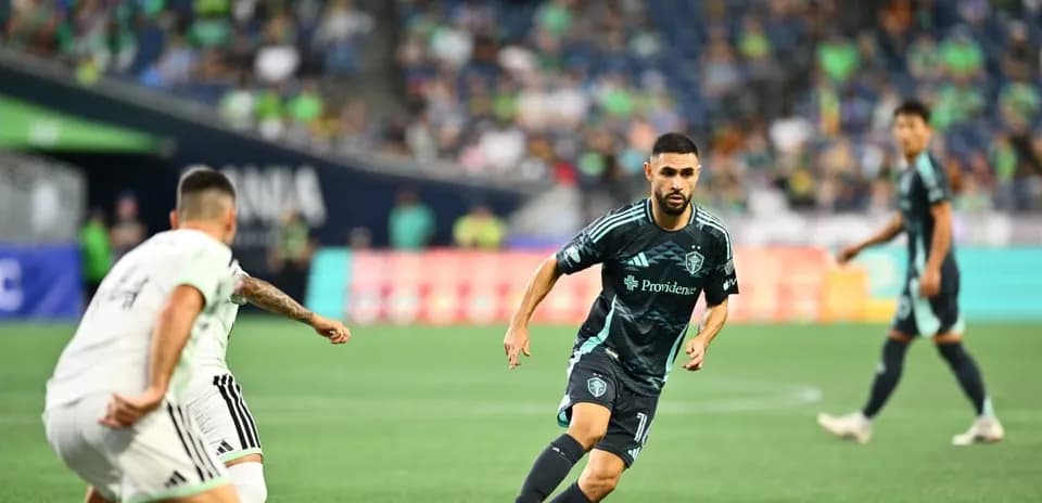 Seattle Sounders player dribbling during match