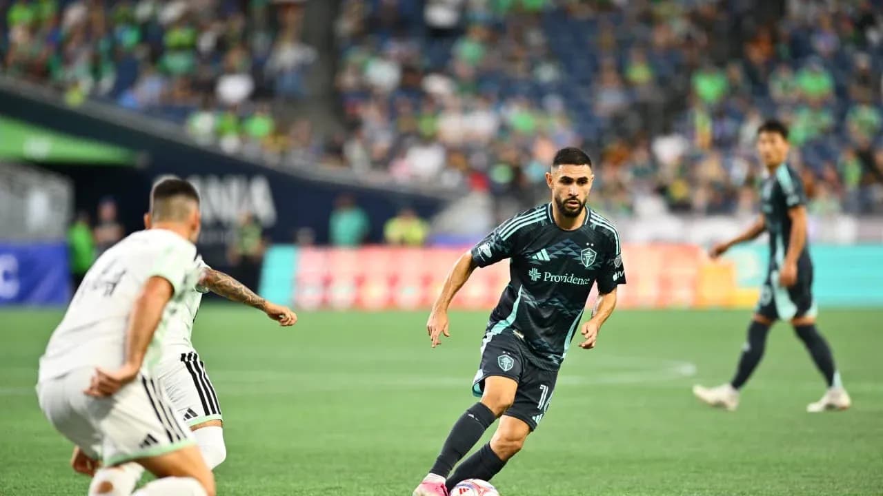 Seattle Sounders player dribbling during match