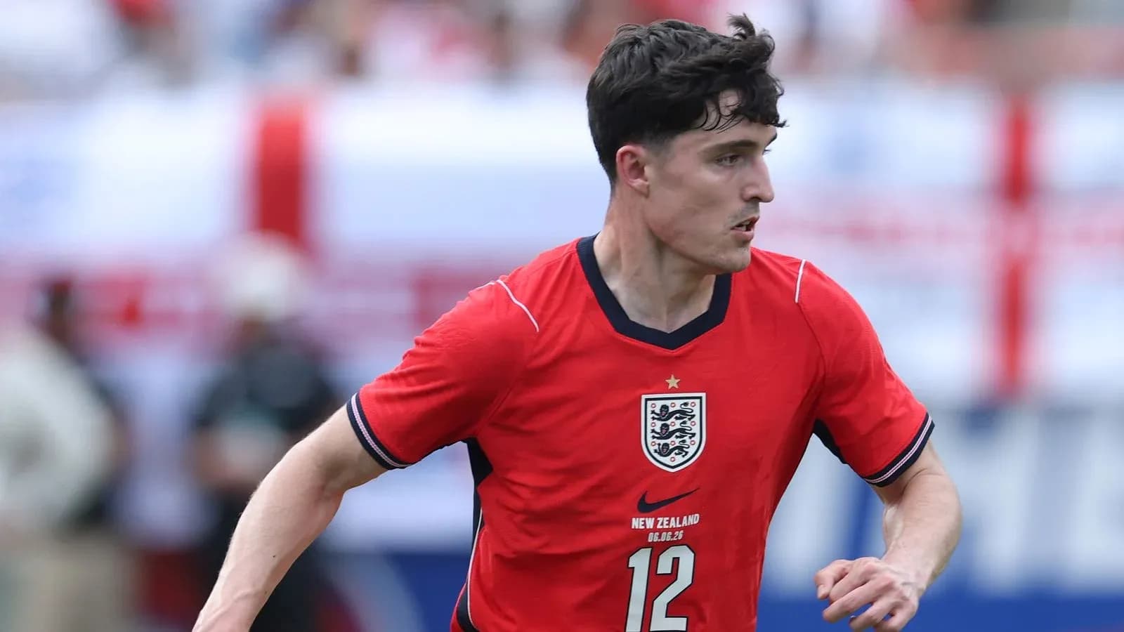 Player in red England jersey running during match