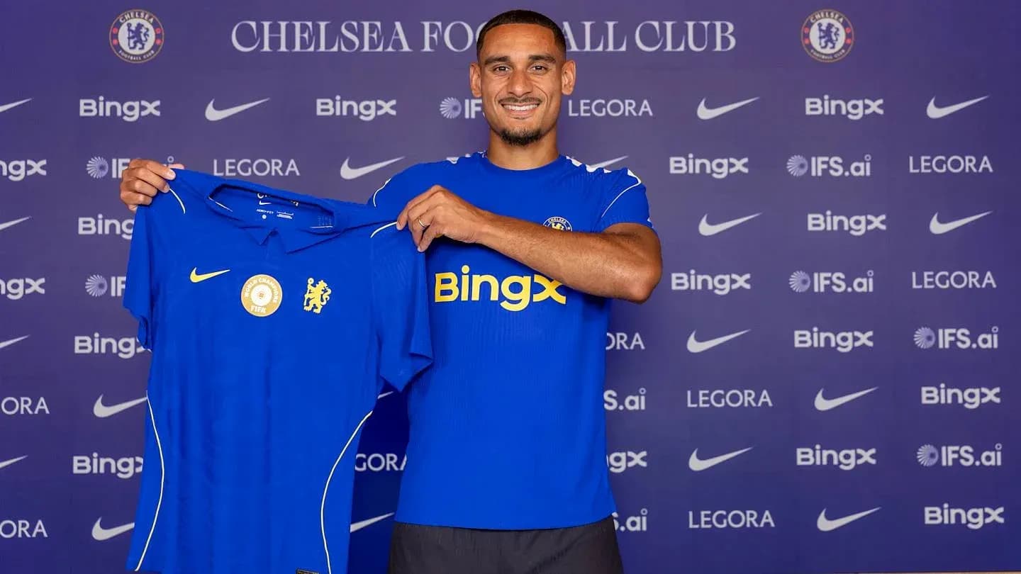 Player holding Chelsea jersey during press event