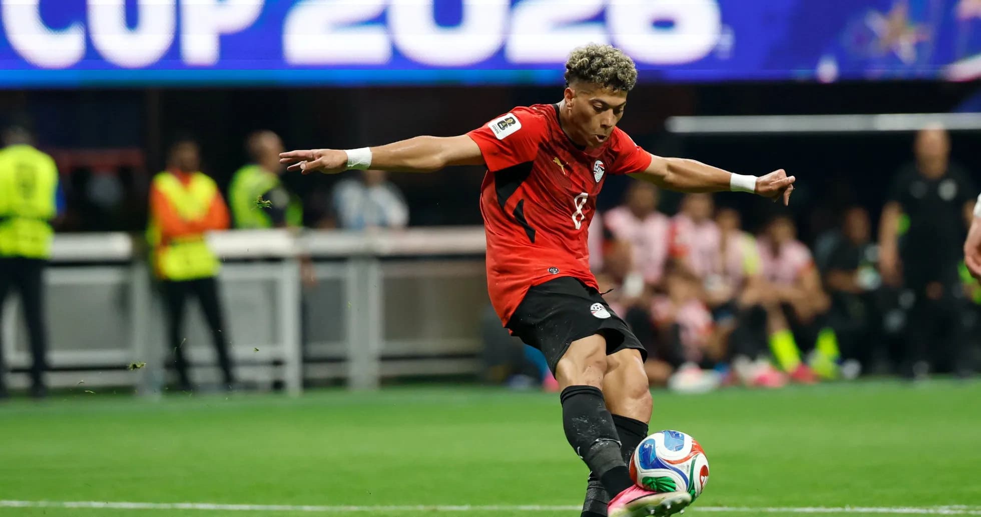 Player kicking the ball during match action