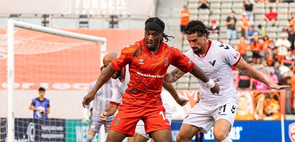 Players contesting for the ball during match