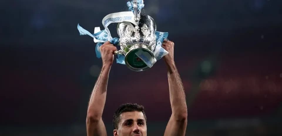 Player lifting trophy with blue ribbons in celebration
