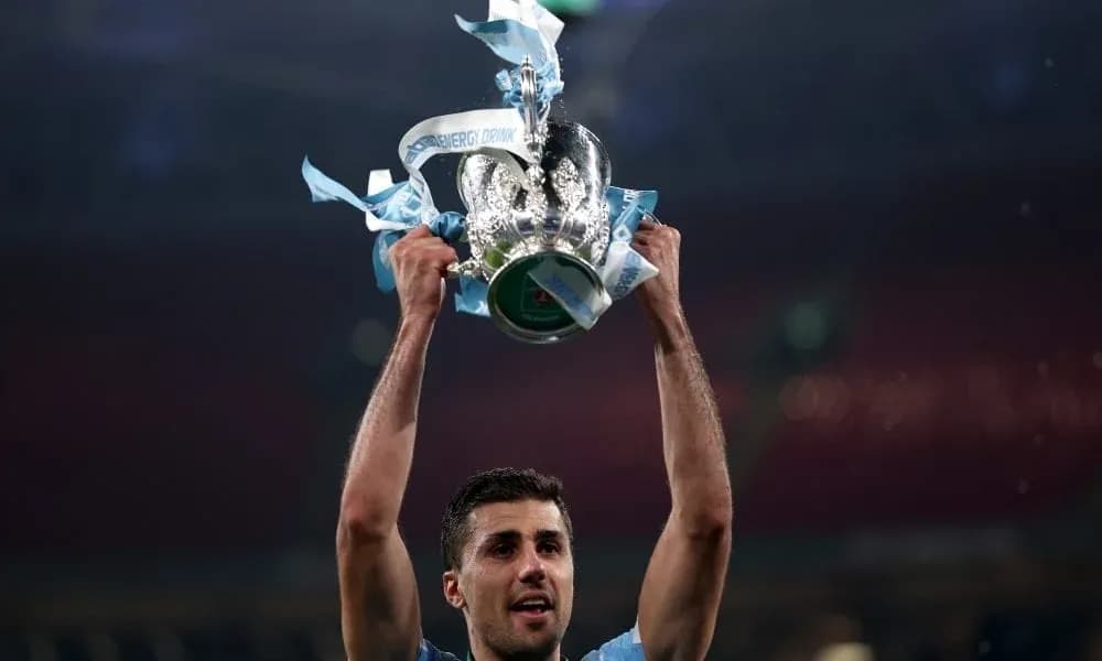 Player lifting trophy with blue ribbons in celebration
