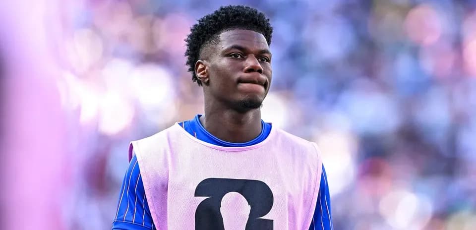 Player in training bib on sidelines during match