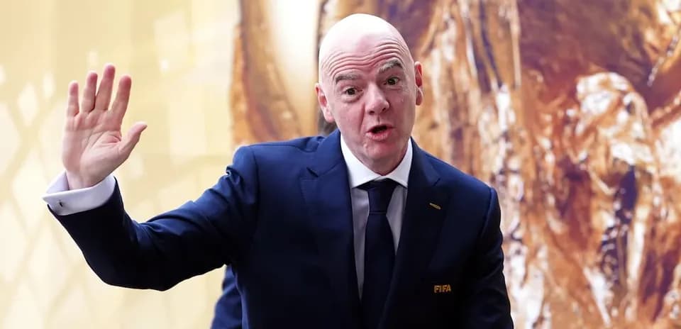 Man in suit gesturing during press event