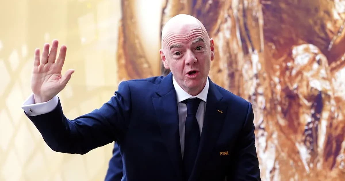 Man in suit gesturing during press event