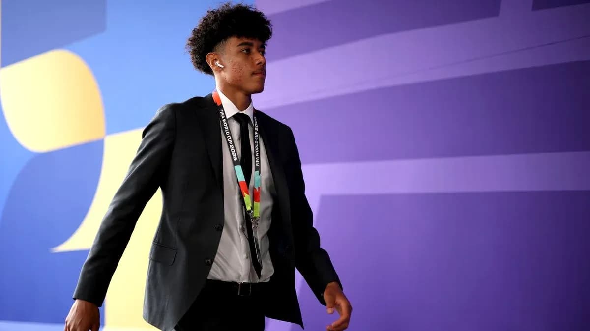 Player walking in suit with FIFA World Cup 2026 lanyard