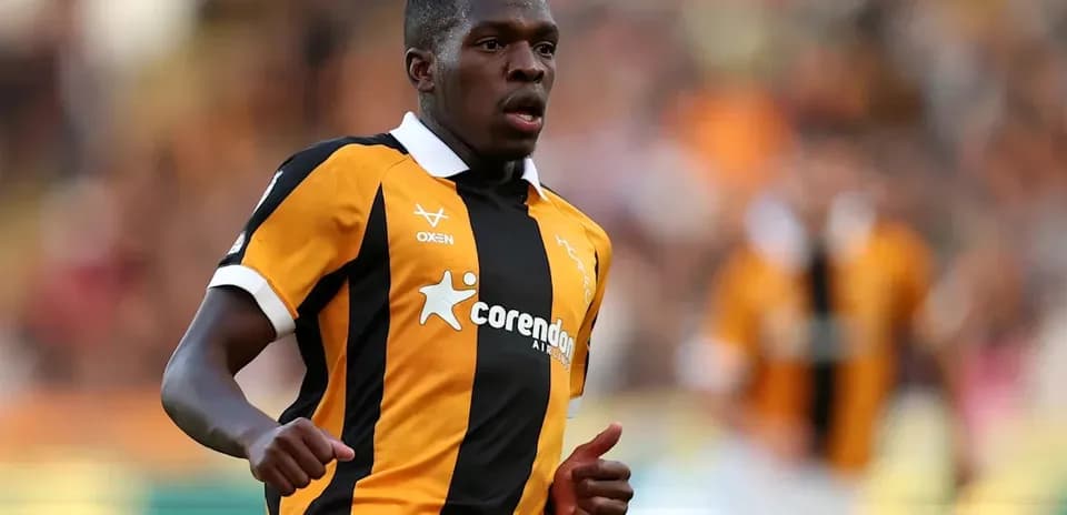 Player running in black and orange team jersey