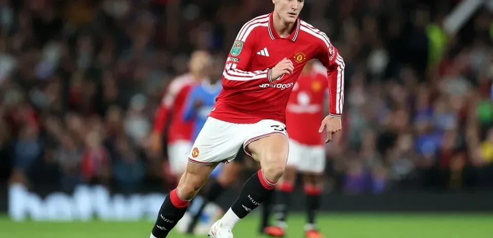 Manchester United player sprinting during a match