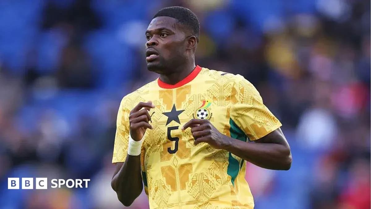 Ghana player in yellow jersey during match