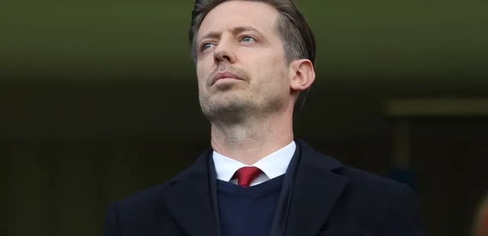Man in suit observing from the stands