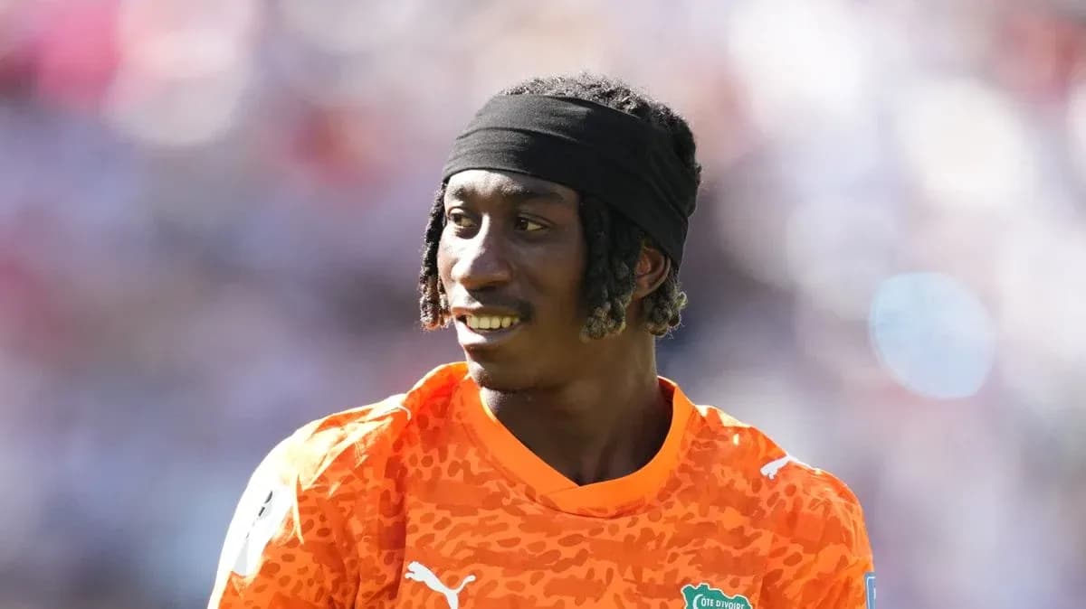 Goalkeeper in orange jersey during warm-up session