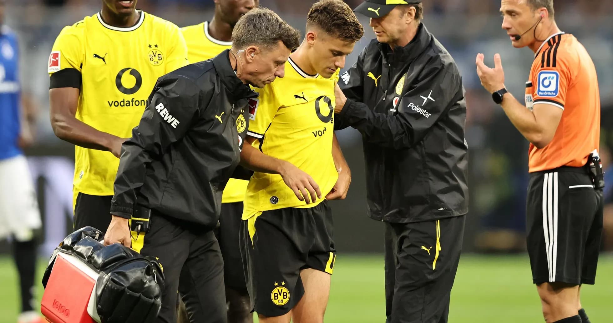 Borussia Dortmund player receiving medical attention on pitch