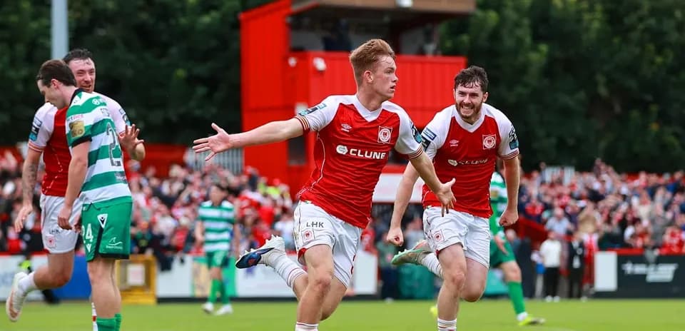 Player celebrating goal with teammates in stadium