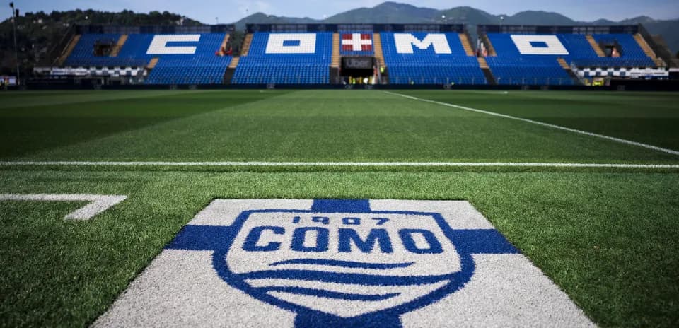 Como stadium with team logo on the pitch