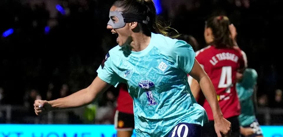 Player celebrating a goal with a mask on