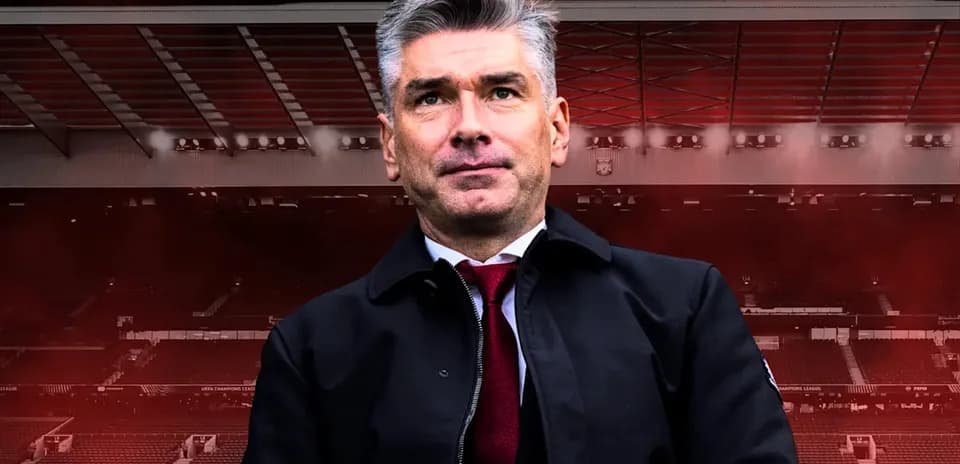 Coach standing in stadium with red background