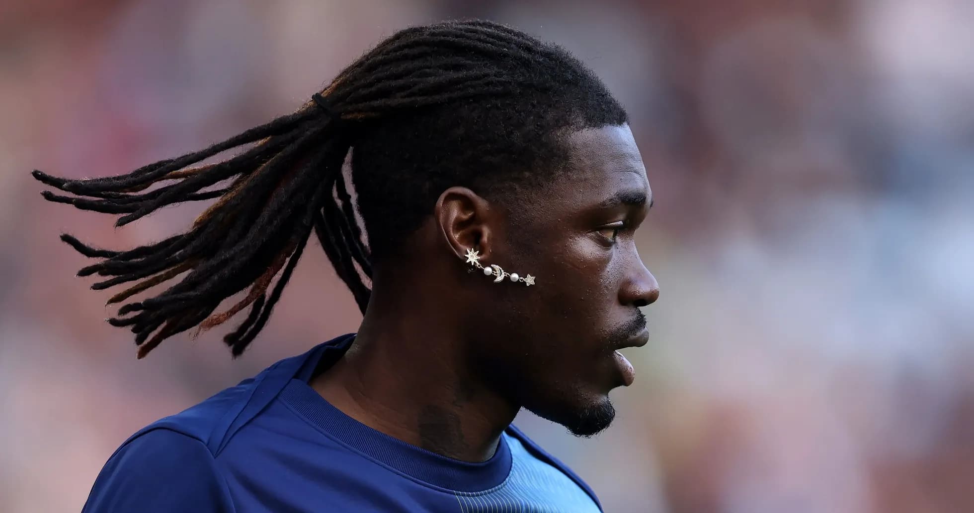 Player with long hair and unique earring profile