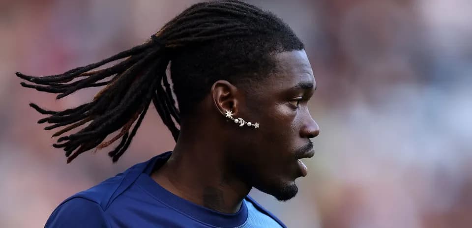 Player with long hair and unique earring profile