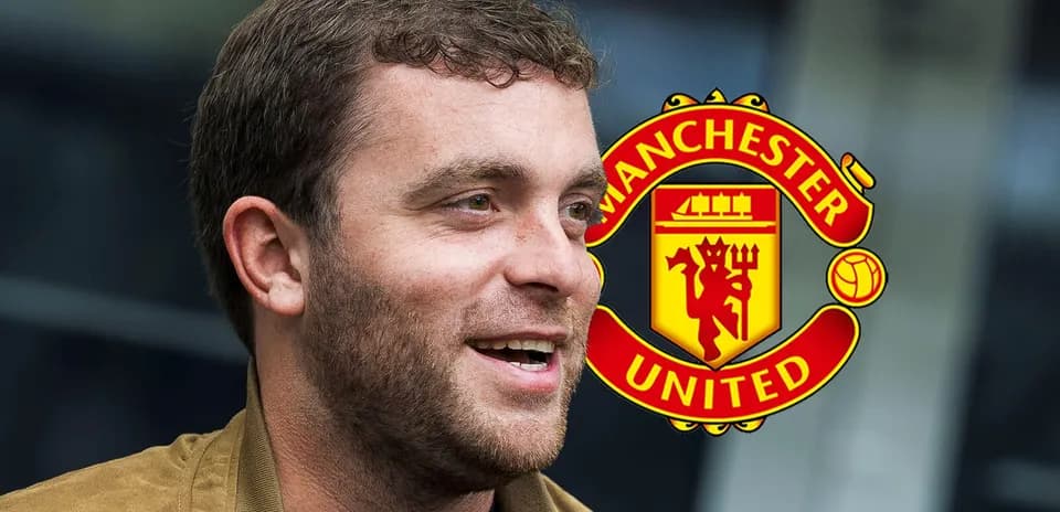 Man talking with Manchester United logo in background