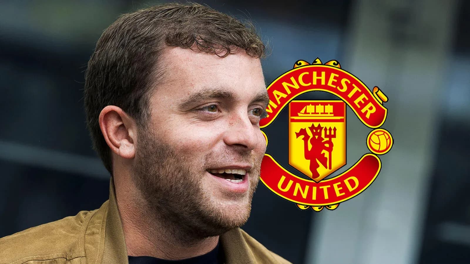 Man talking with Manchester United logo in background