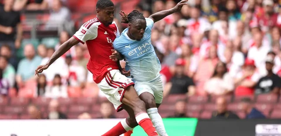 Two players contesting the ball during match