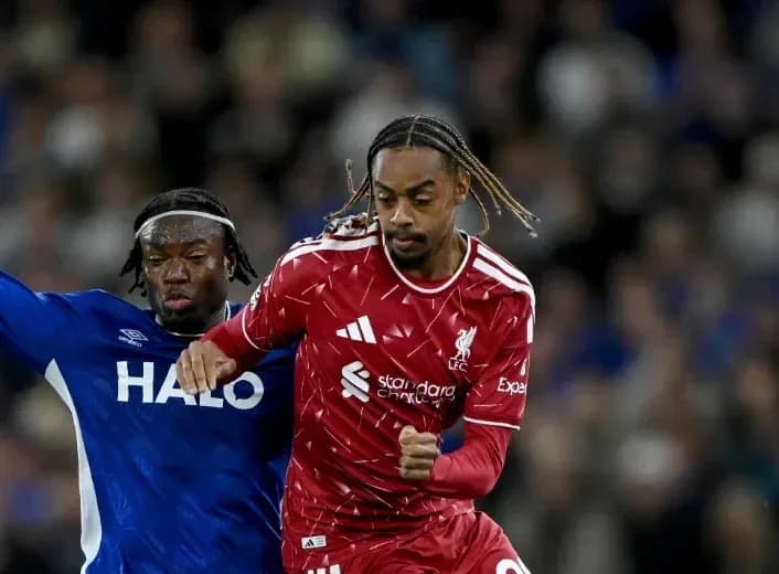 Liverpool player running past opponent during match
