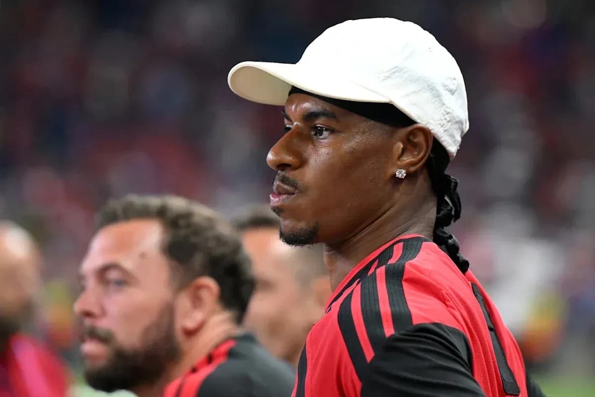 Player in red jersey observing the match