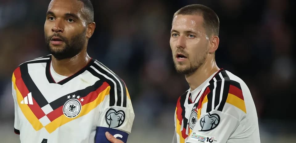 Two German players during a match, one wearing captain's armband