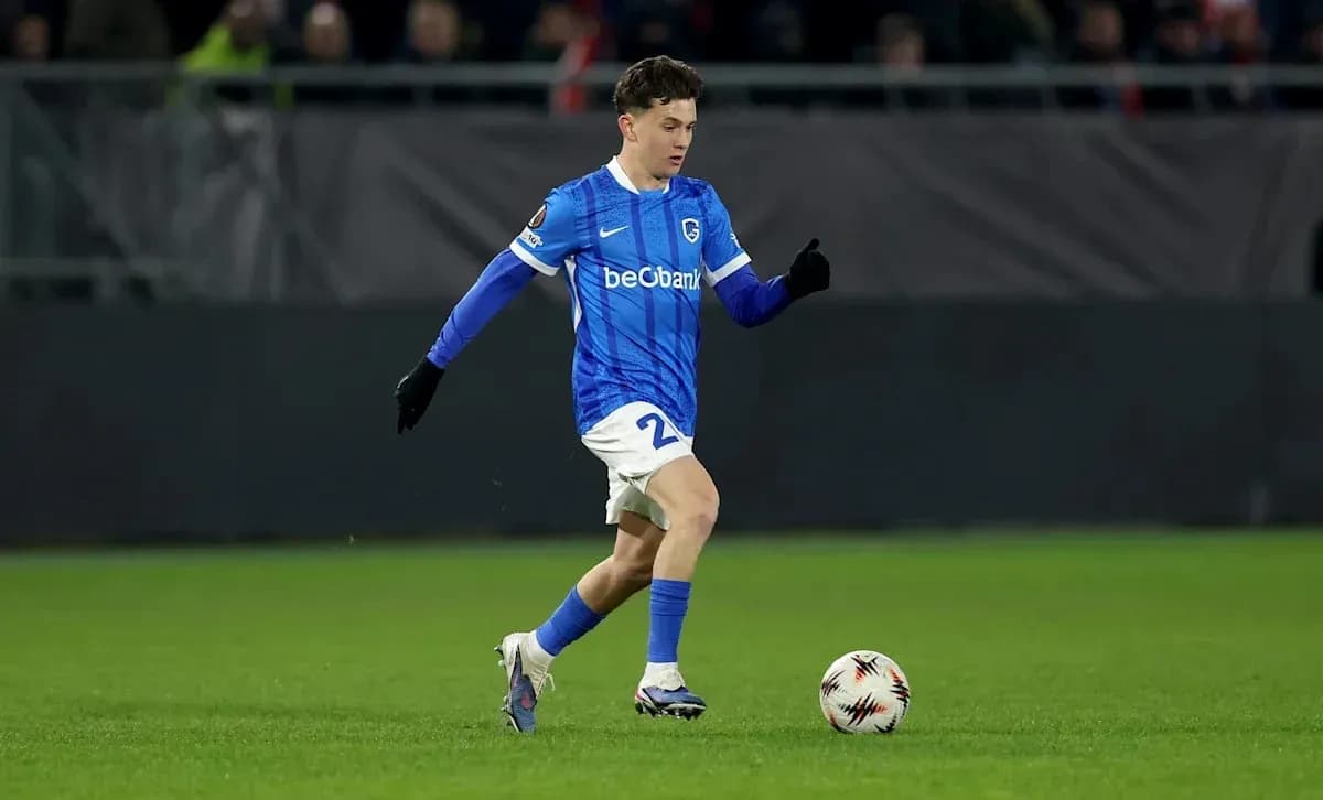 Player in blue kit dribbling a soccer ball