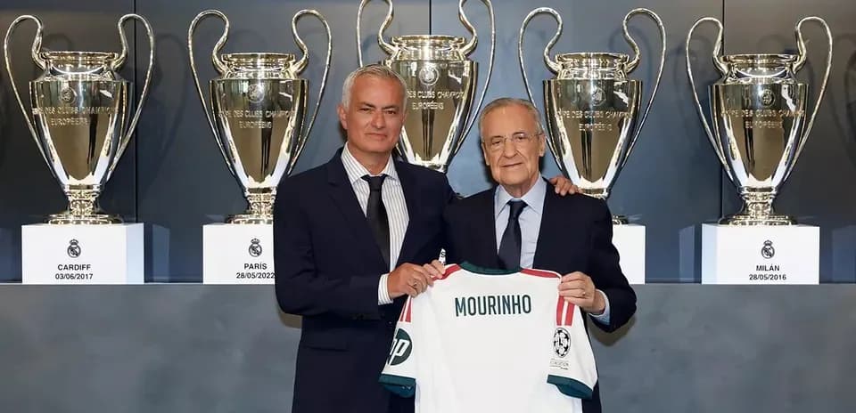 Jose Mourinho holding a jersey with club president