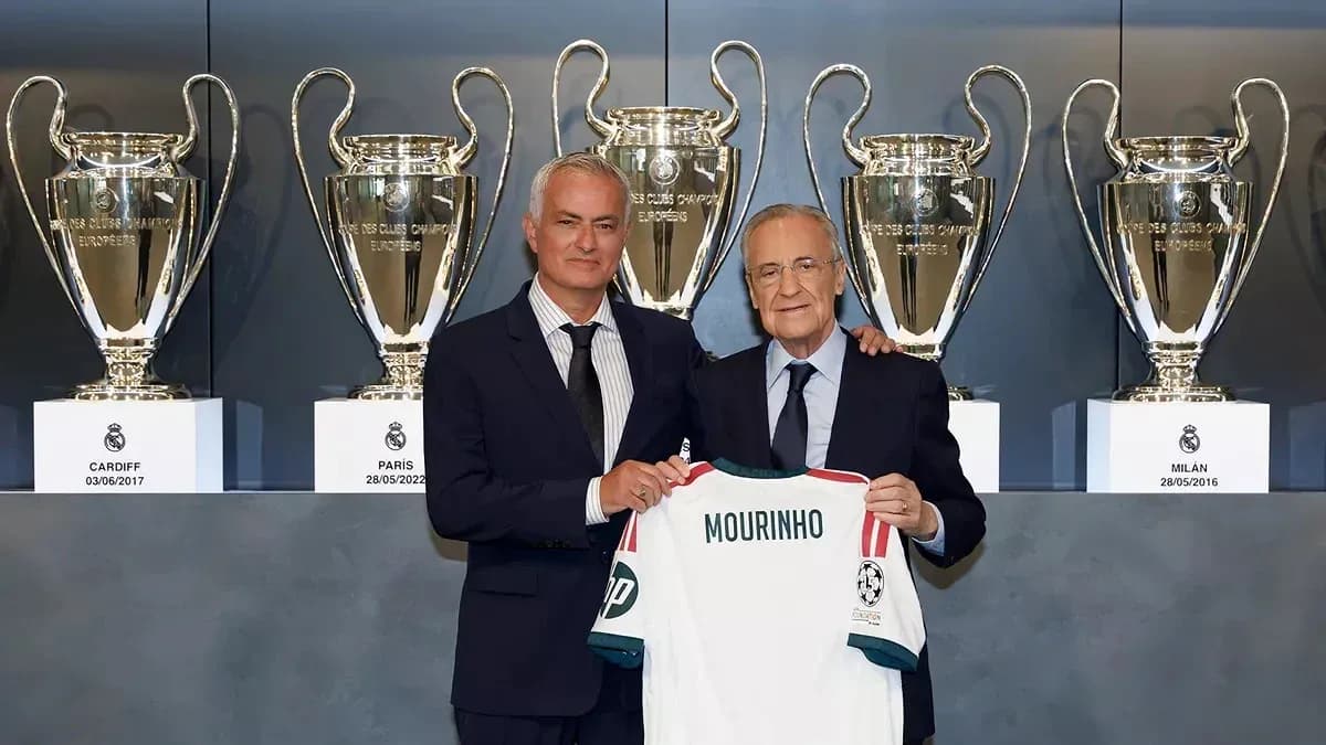 Jose Mourinho holding a jersey with club president