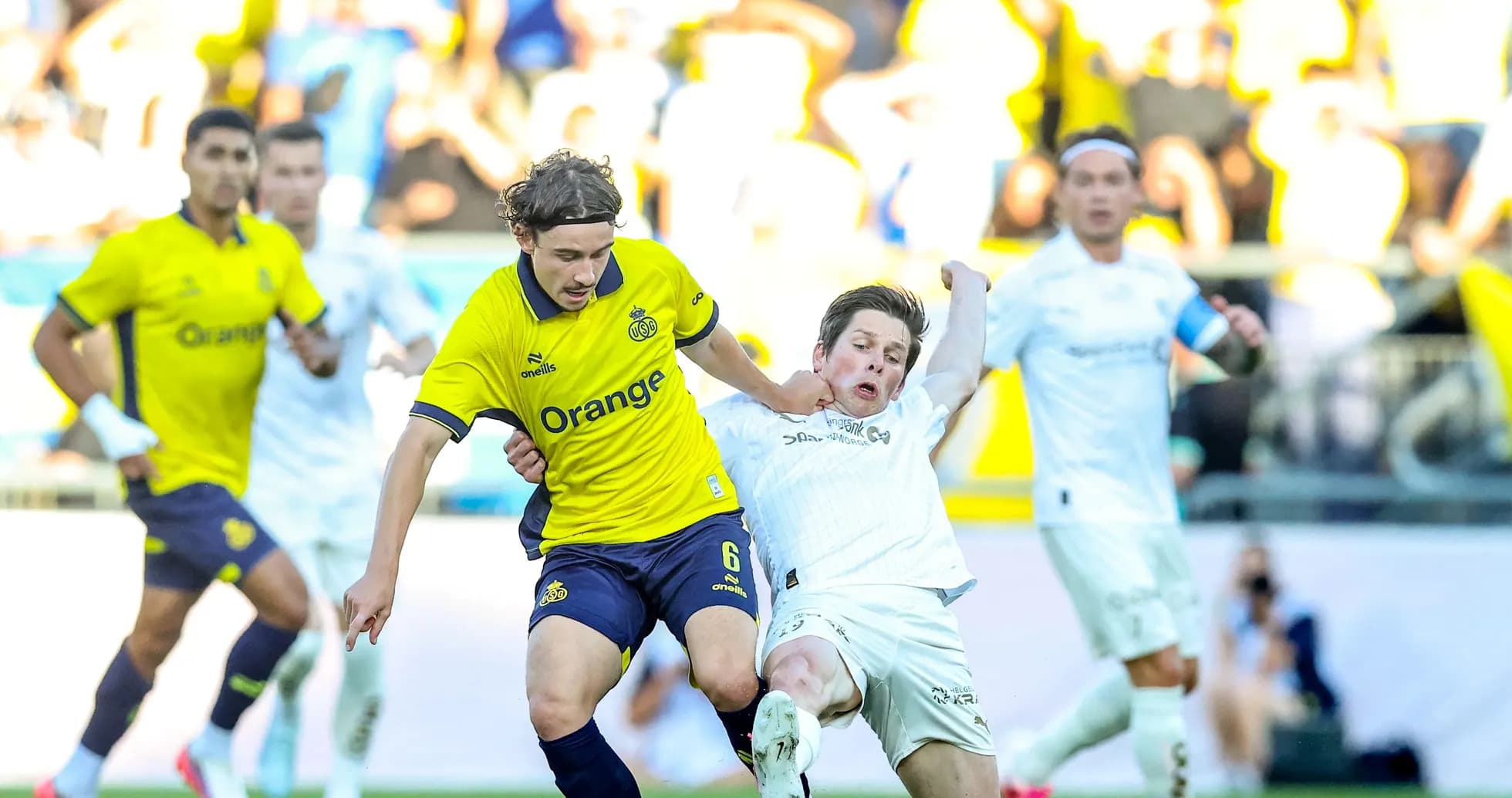 Bodo/Glimt player challenging Union St. Gilloise opponent