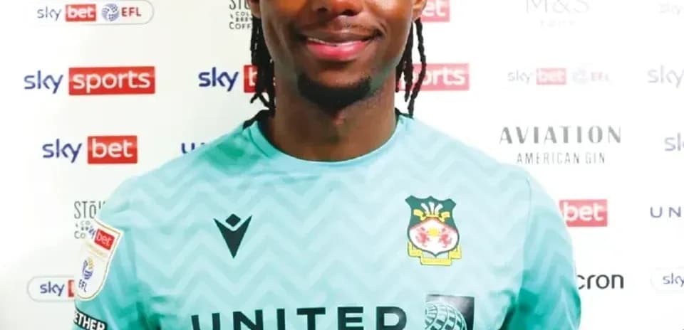 Goalkeeper posing in team jersey with sponsors