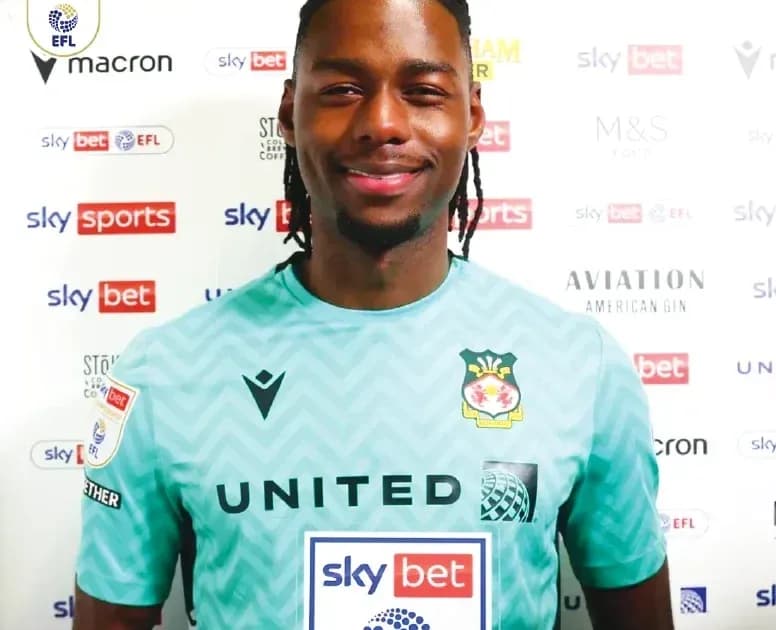 Goalkeeper posing in team jersey with sponsors