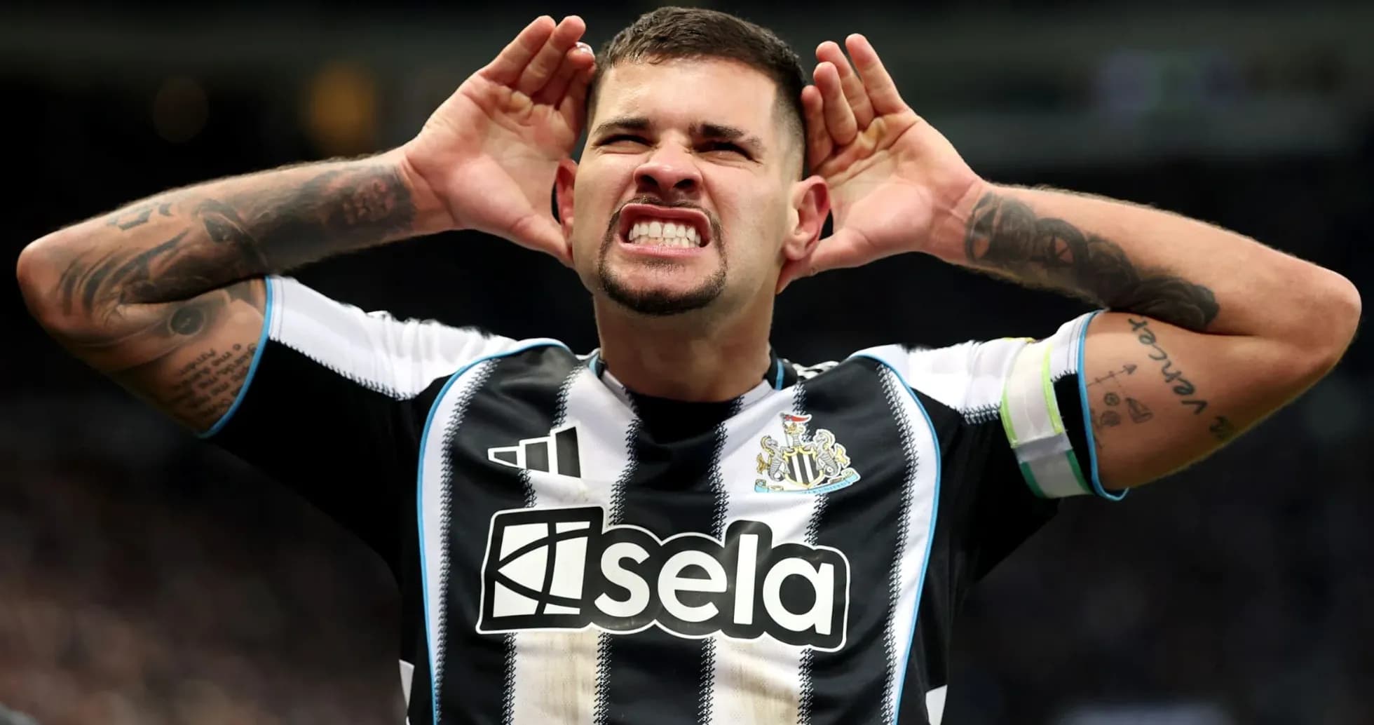 Player celebrating with hands on ears after scoring