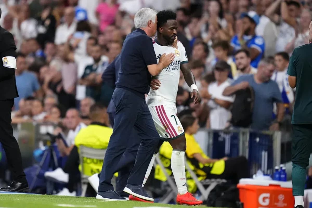 Coach guiding player off the field during match