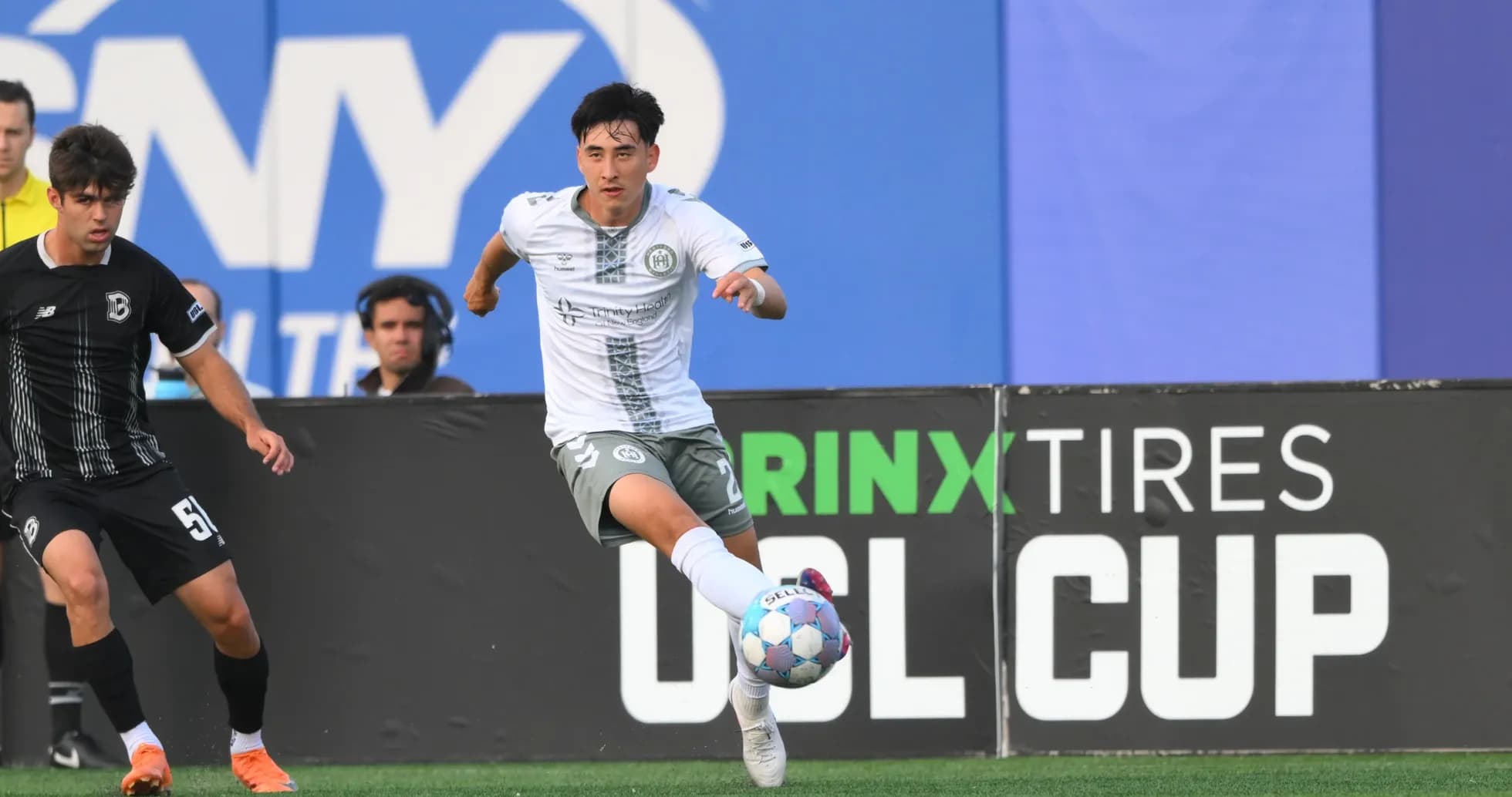 Player dribbling the ball in USL Cup match