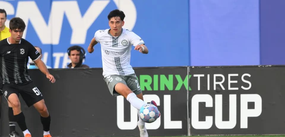 Player dribbling the ball in USL Cup match