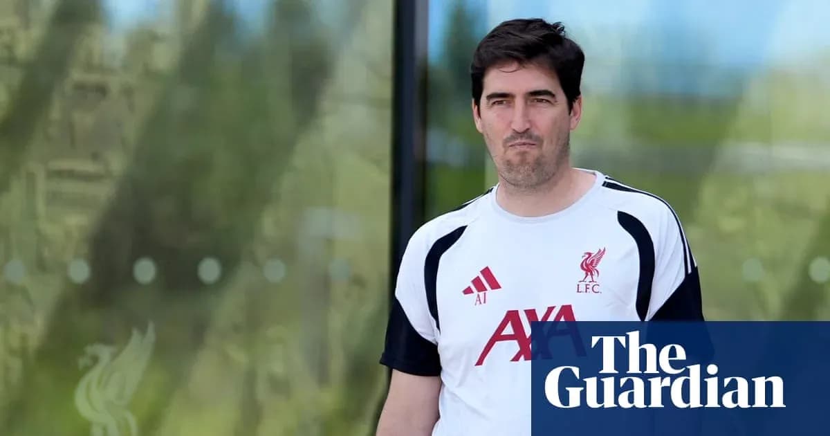 Man in Liverpool training kit walking outside