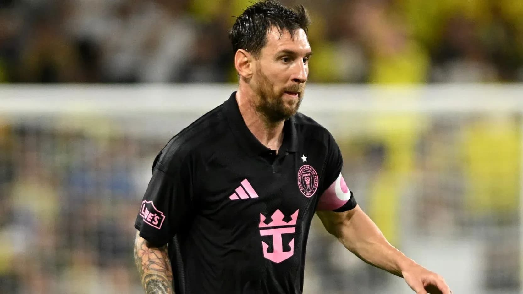 Player in black jersey running during soccer match