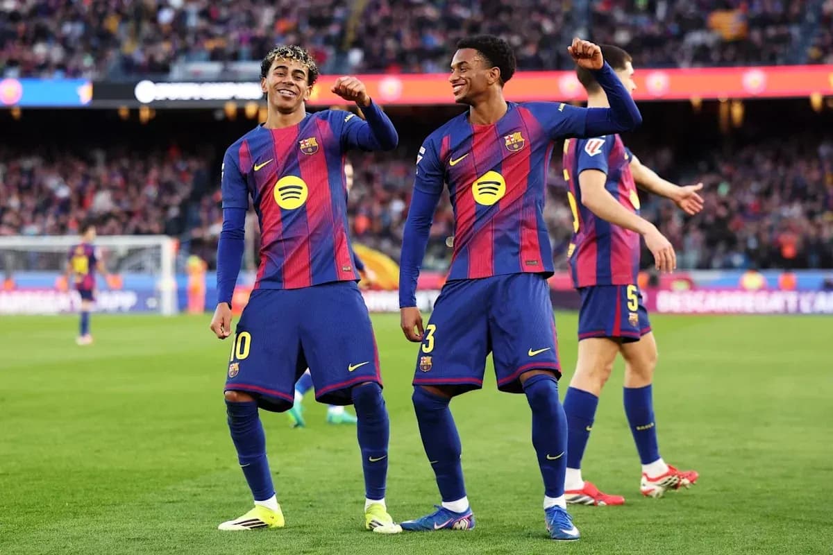 Two FC Barcelona players celebrating on the pitch