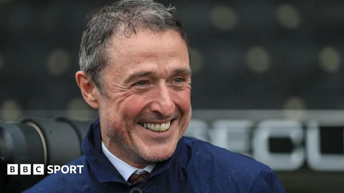 Smiling coach during post-match interview at stadium
