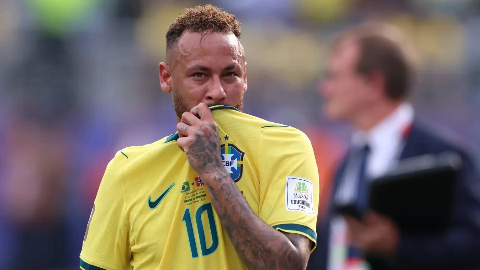 Neymar holding his jersey during a match