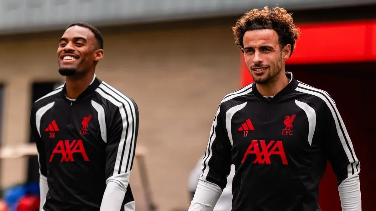 Two Liverpool players walking in training gear